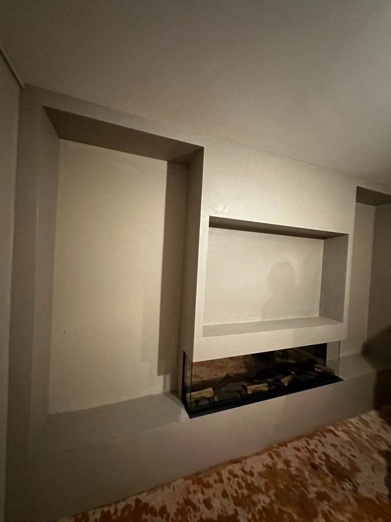 Finished custom media wall fireplace and tv alcove skimming