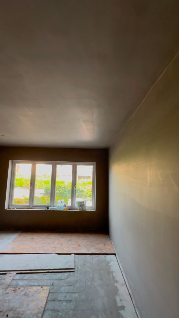 Finished living room plastering and skimming with window view